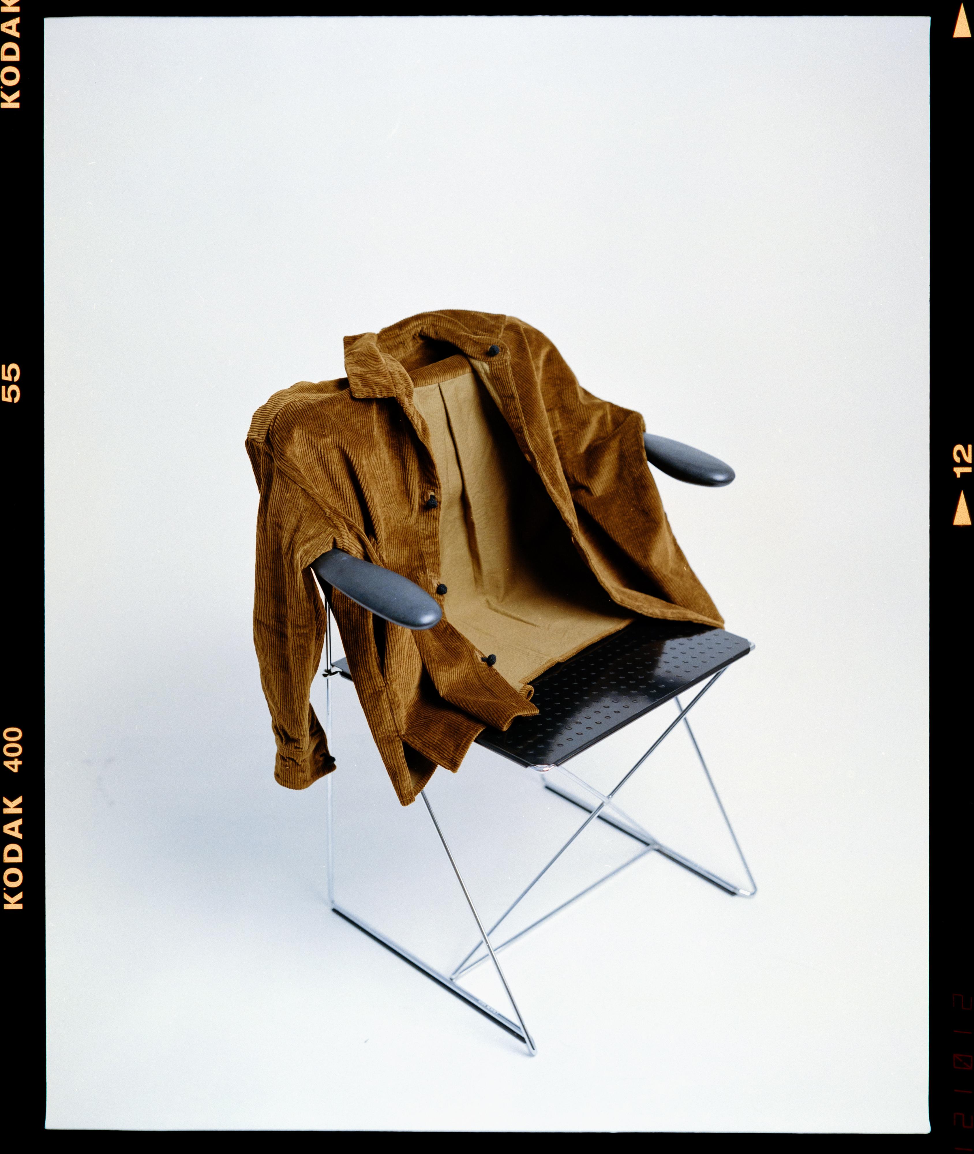 A corduroy jacket resting on a chair, framed like a Kodak film scan