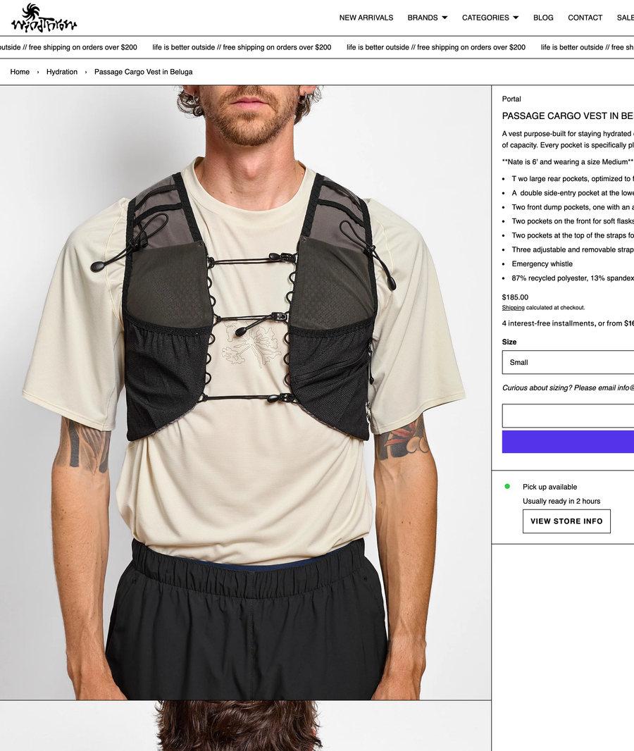 The Windthrow product page for the Passage Cargo Vest behind the sales associate building the rest of the outfit